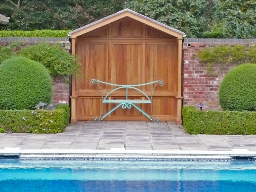 wooden arbour situated by a swimming pool