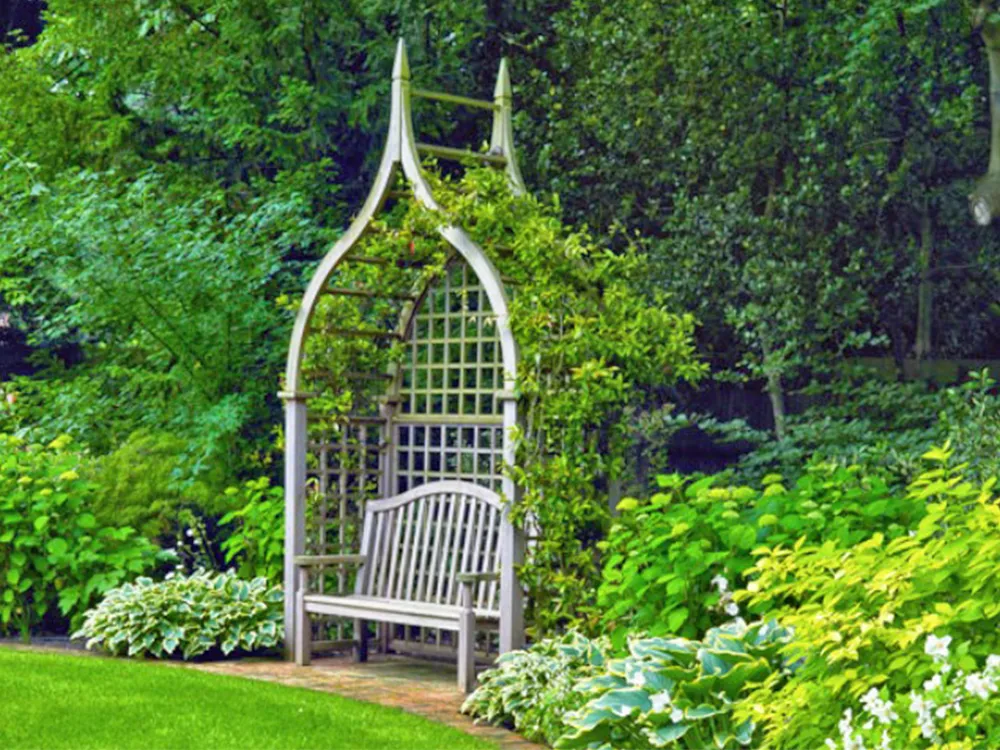 gothic arbour in a garden with seating